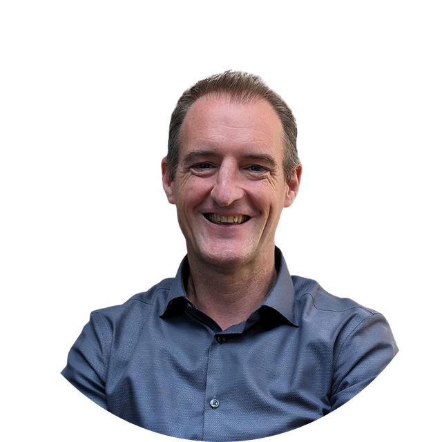 Smiling person in a blue button-up shirt against a white background