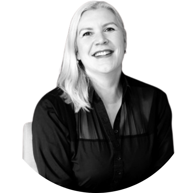 Smiling blonde woman in a black blouse against a white background