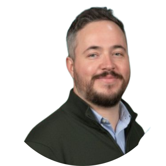 Portrait of a smiling man with short dark hair and a beard on a white background