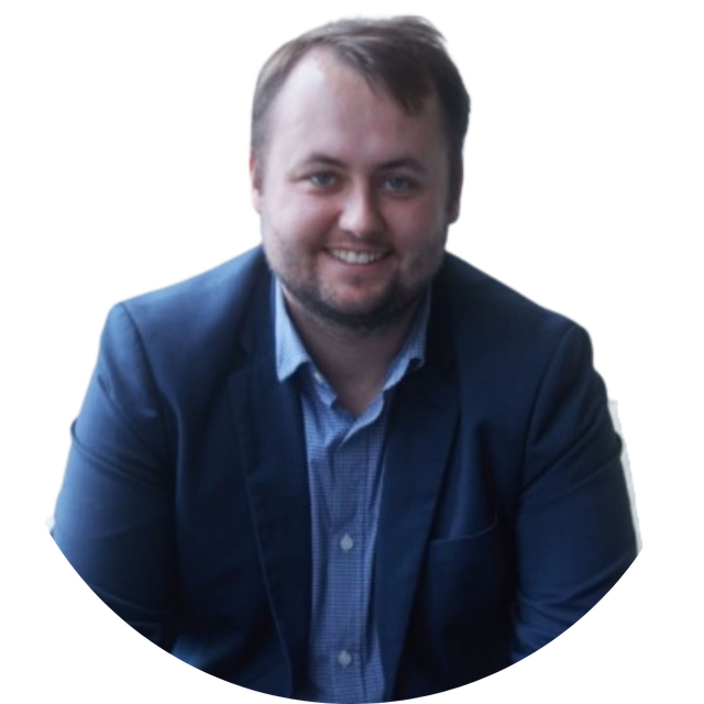 Smiling man in a blue blazer and shirt against a white background