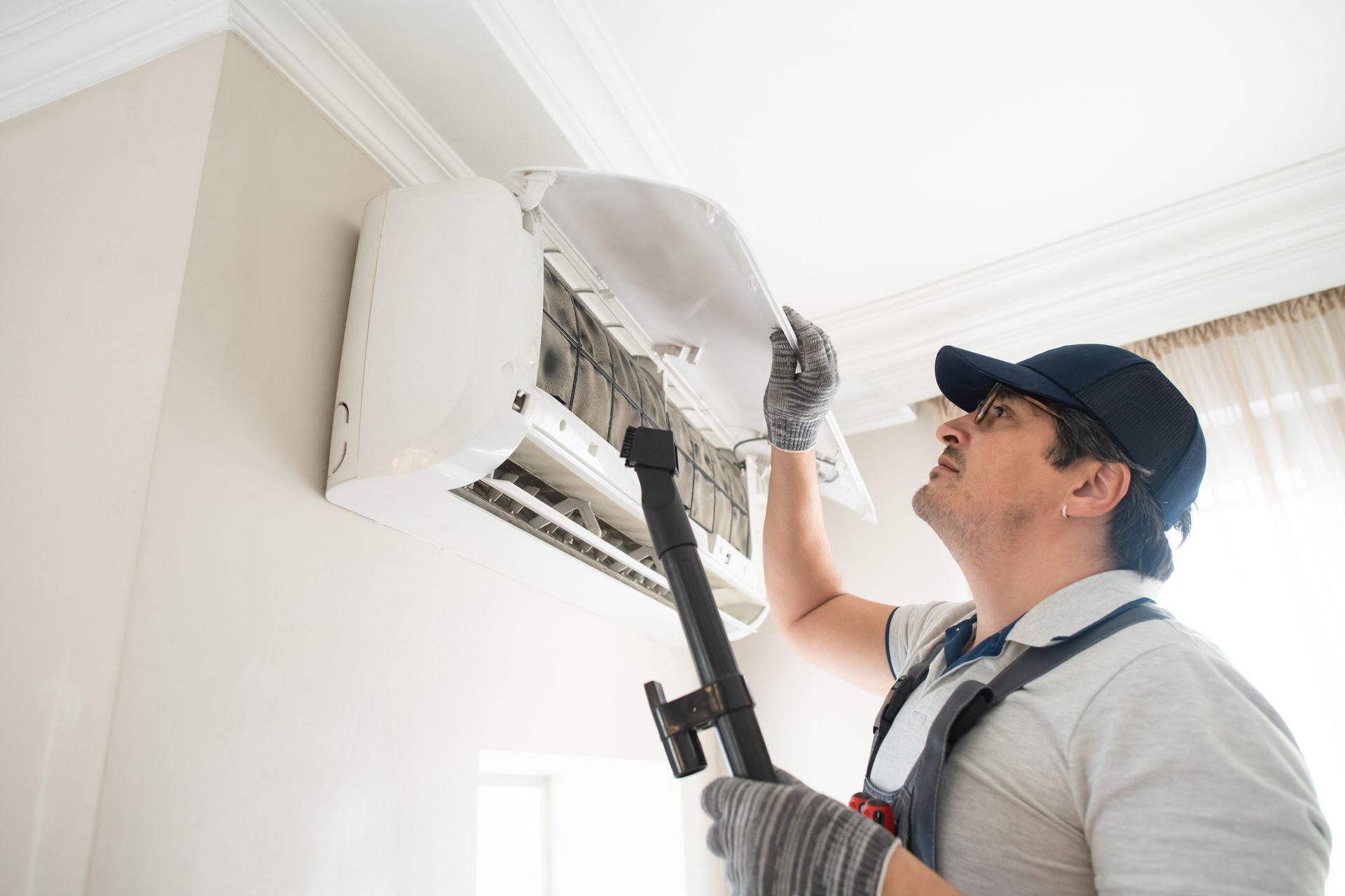 Technician cleaning an HVAC unit