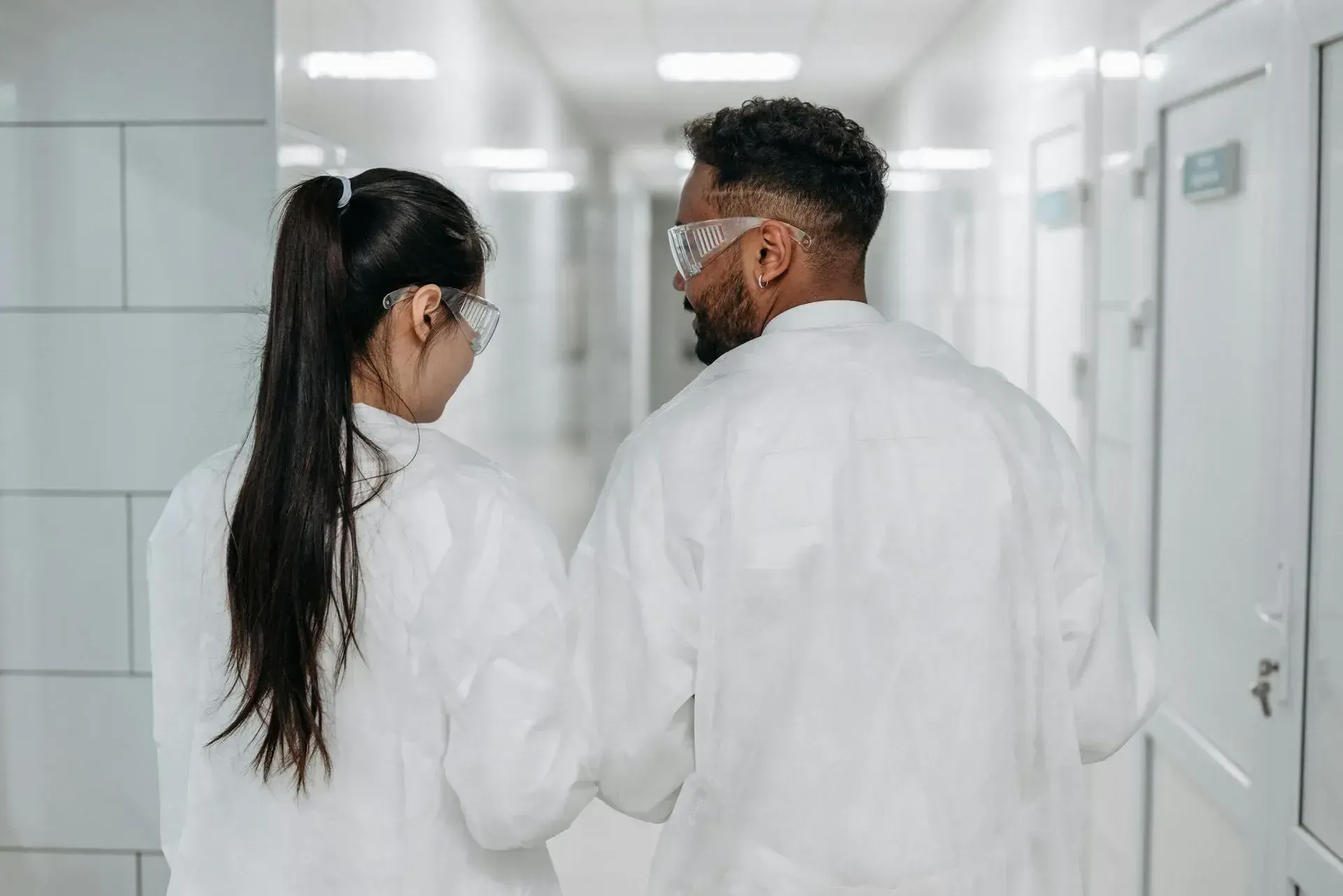 2 scientists walking with back to the camera