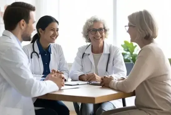 Doctors smiling around a table