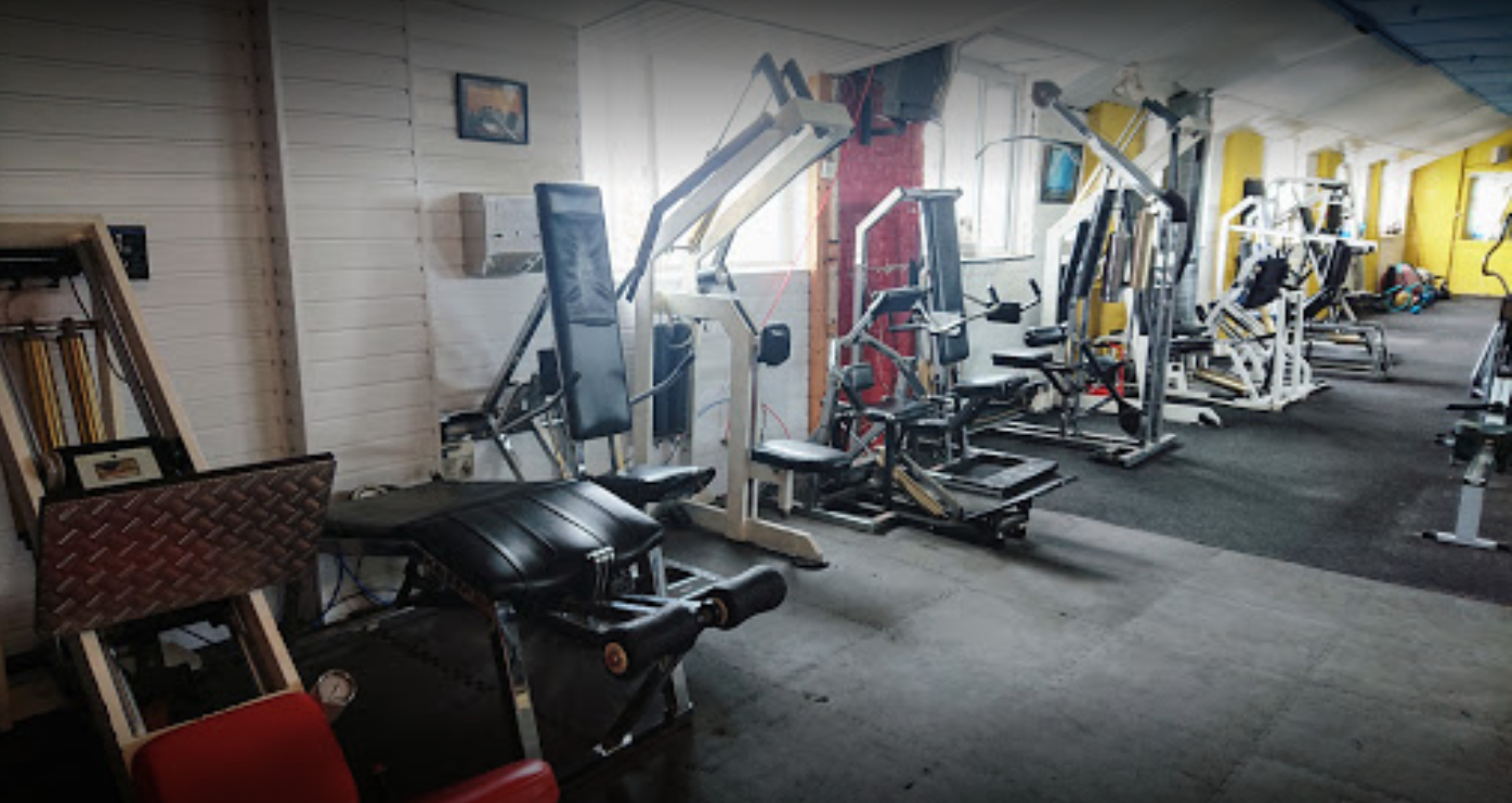 A gym filled with lots of exercise equipment.