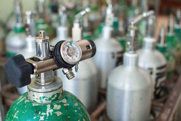 A Close Up Of An Oxygen Tank With A Regulator On Top Of It — ADR Engineering in Collinsville, QLD
