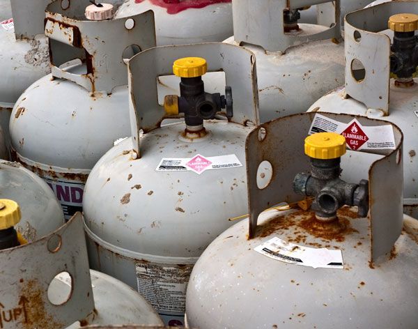 A Bunch Of Propane Tanks Are Stacked On Top Of Each Other — ADR Engineering in Collinsville, QLD