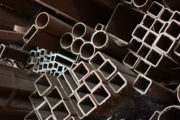 A Bunch Of Metal Pipes Are Stacked On Top Of Each Other — ADR Engineering in Collinsville, QLD