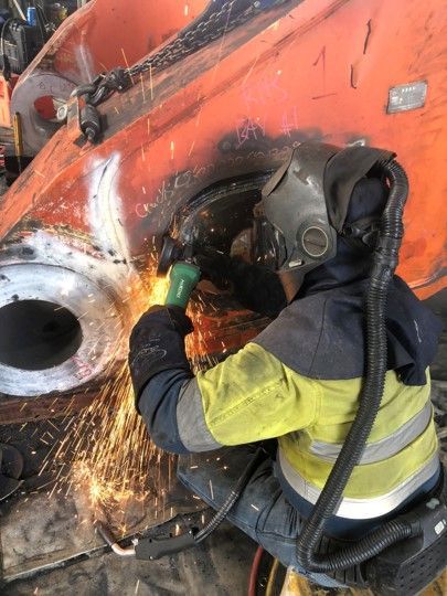 A Man Wearing A Gas Mask Is Welding A Piece Of Metal — ADR Engineering in Collinsville, QLD