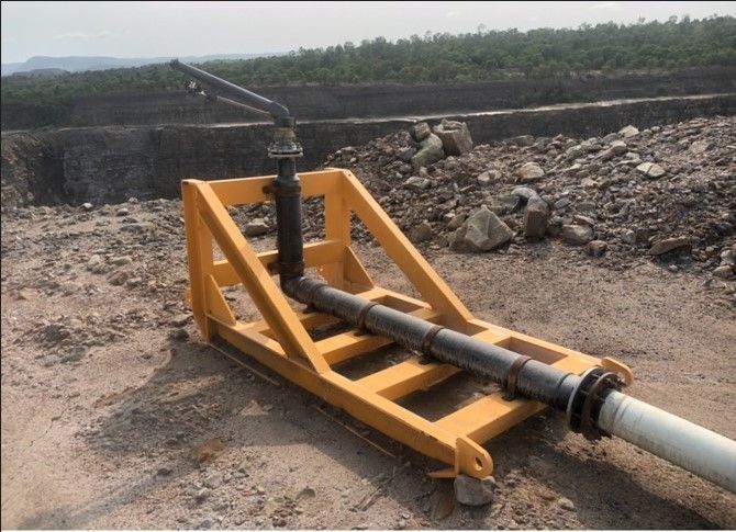 A Large Pipe Is Attached To A Yellow Frame In The Dirt — ADR Engineering in Collinsville, QLD