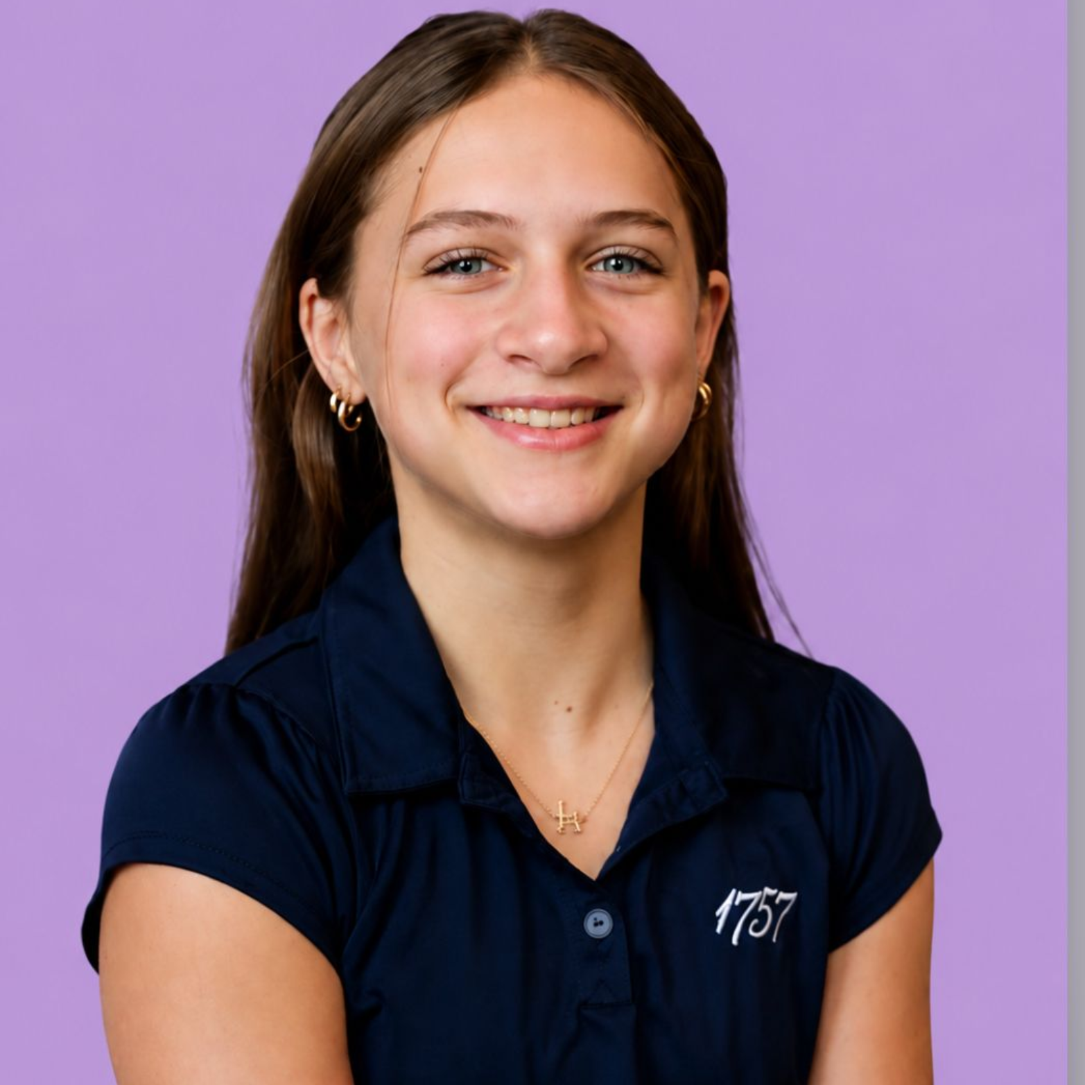 Smiling woman with long brown hair against a purple background