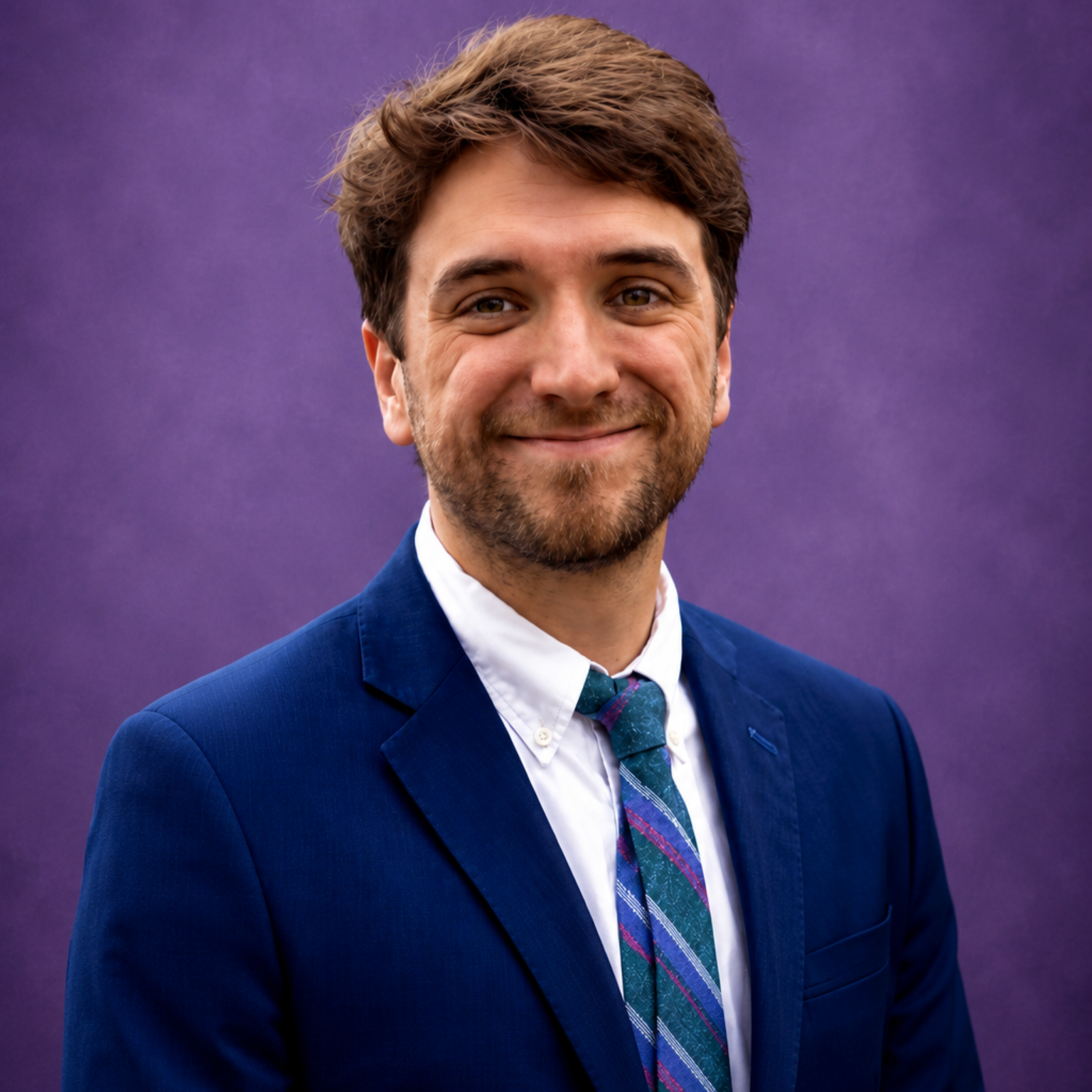 Smiling woman with long brown hair against a purple background