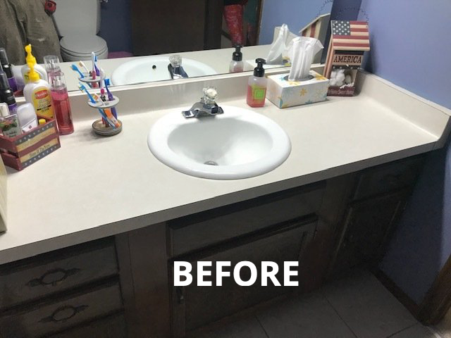 Bathroom vanity with sink, mirror, toiletries, and dark wood cabinets against a purple wall