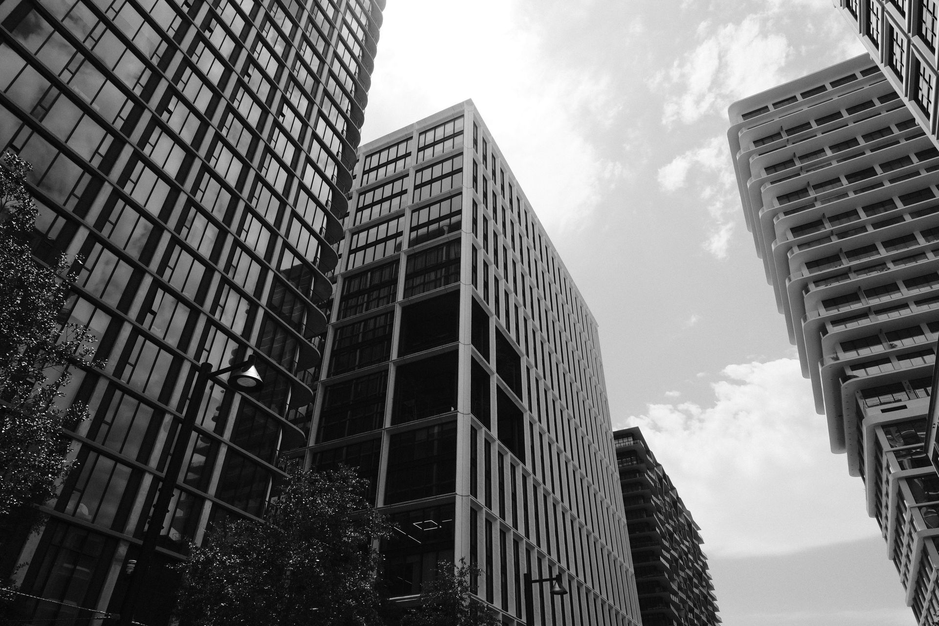 A black and white photo of tall buildings in a city
