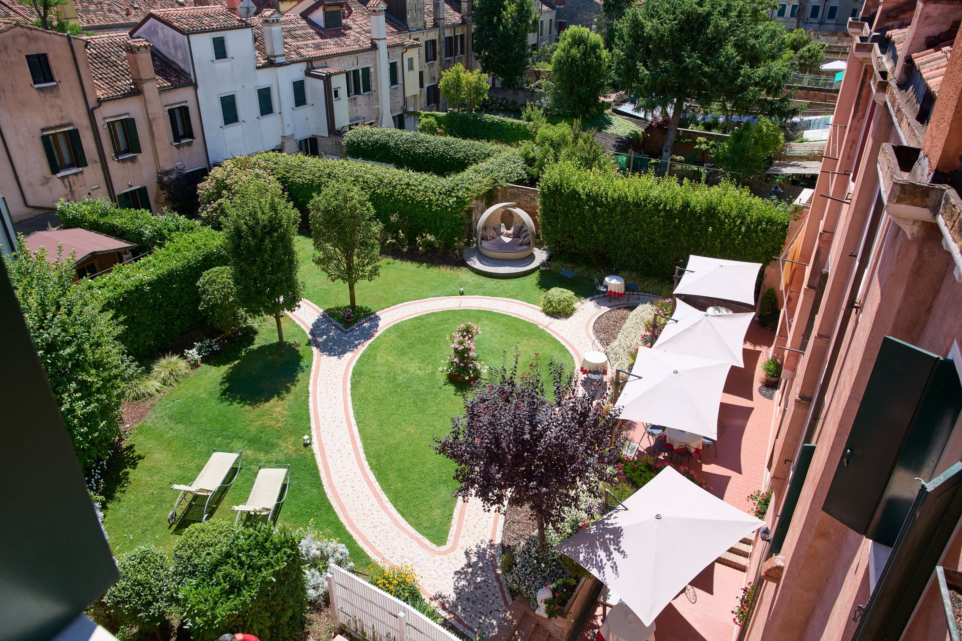 An aerial view of a garden with umbrellas and chairs