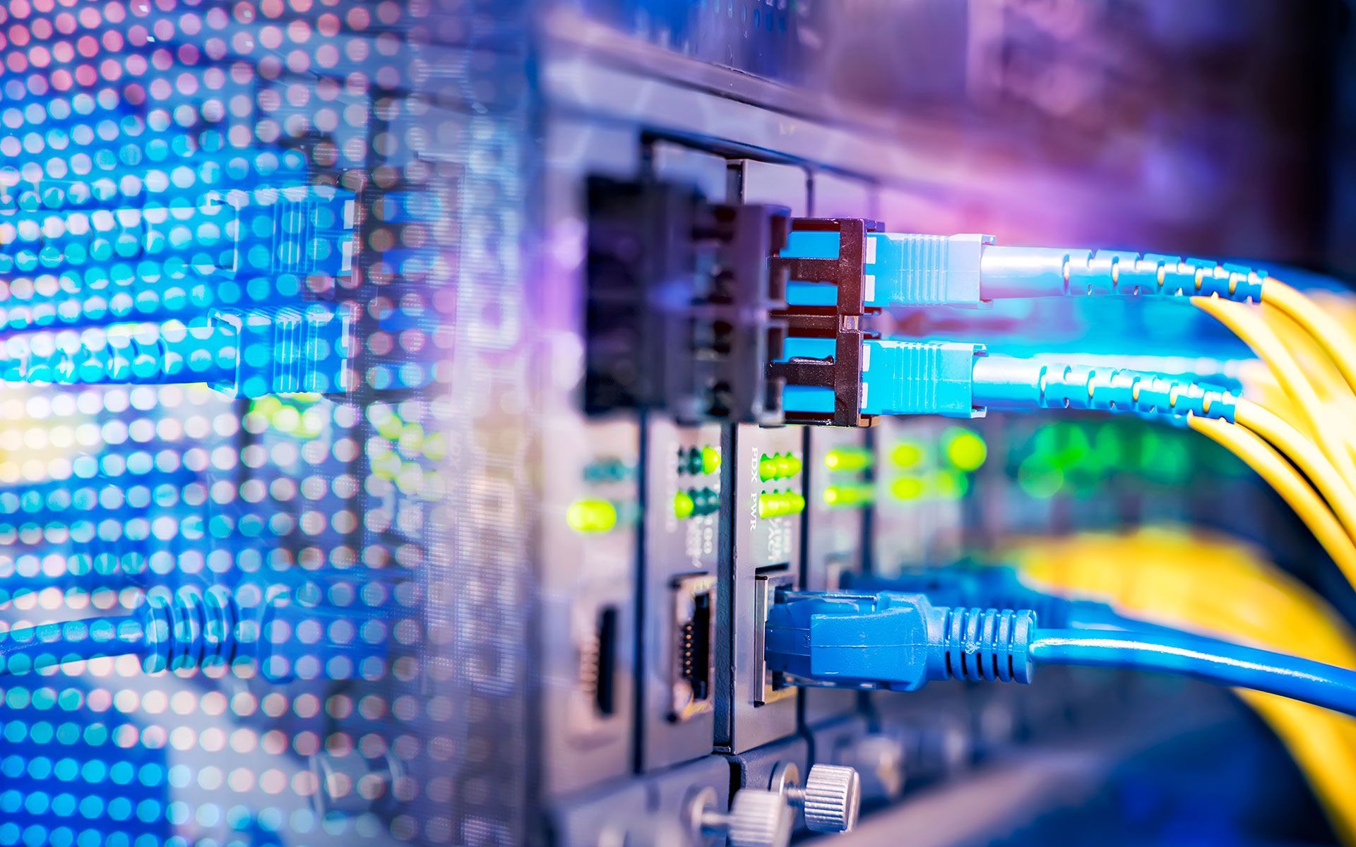 A bunch of cables are connected to a server in a data center.