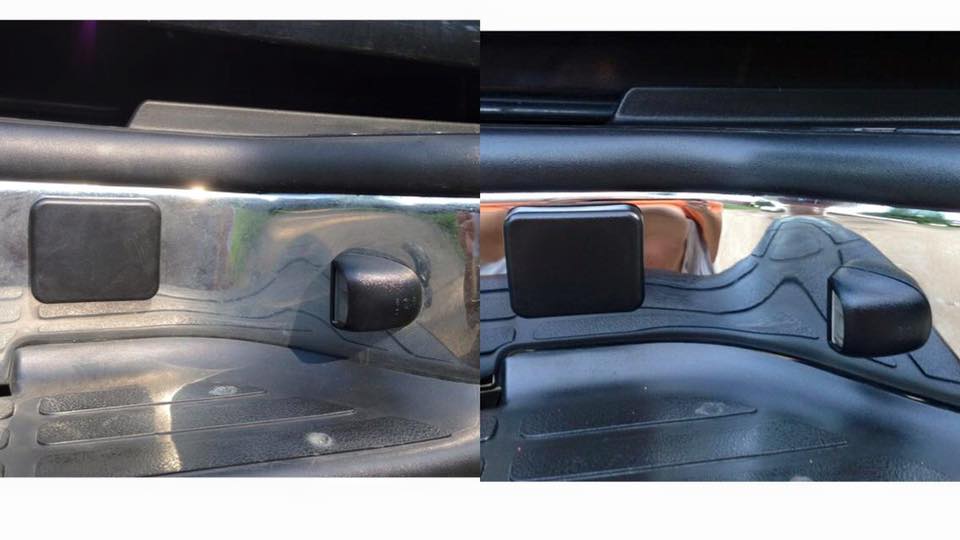 Close-up of black car interior door panel with window and lock controls.