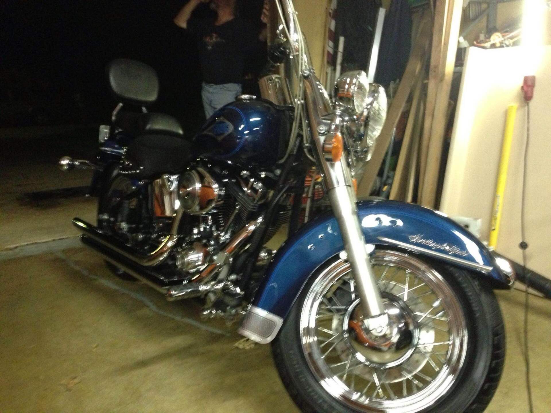 Blue and chrome motorcycle parked in a garage at night