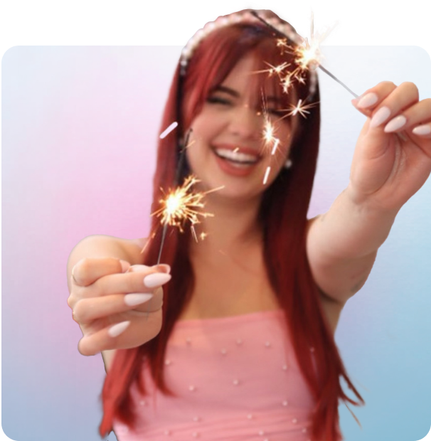 A woman with red hair is holding a sparkler in her hand.