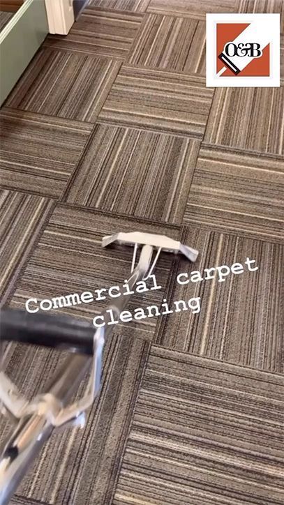 Carpet cleaning underway on a gray-brown patterned commercial carpet, with cleaning wand visible.