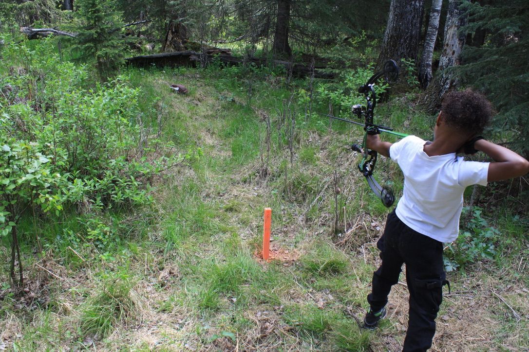 Young Archer shooting arrow at target