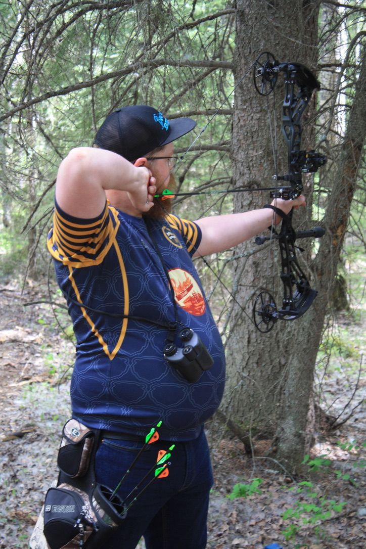 Archer shooting arrow at target