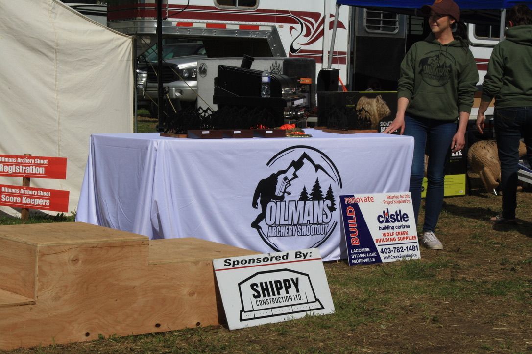 A woman stands behind a table with a sign that says shippy