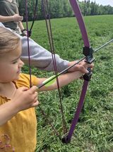 Archer shooting arrow at target