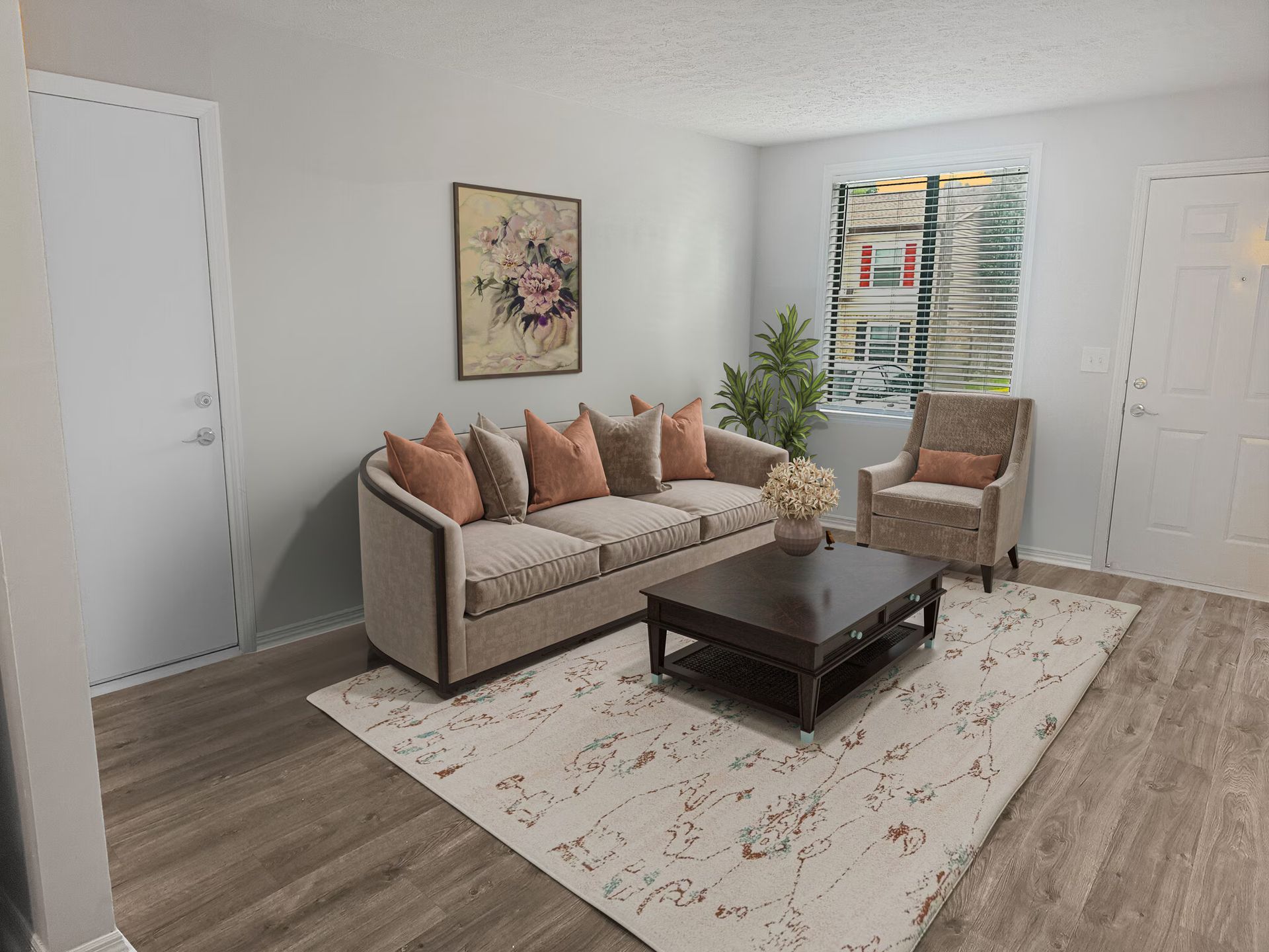 Living room with sofa, armchair, rug, and coffee table. Neutral colors and natural light at Glastonbury Woods Apartments.