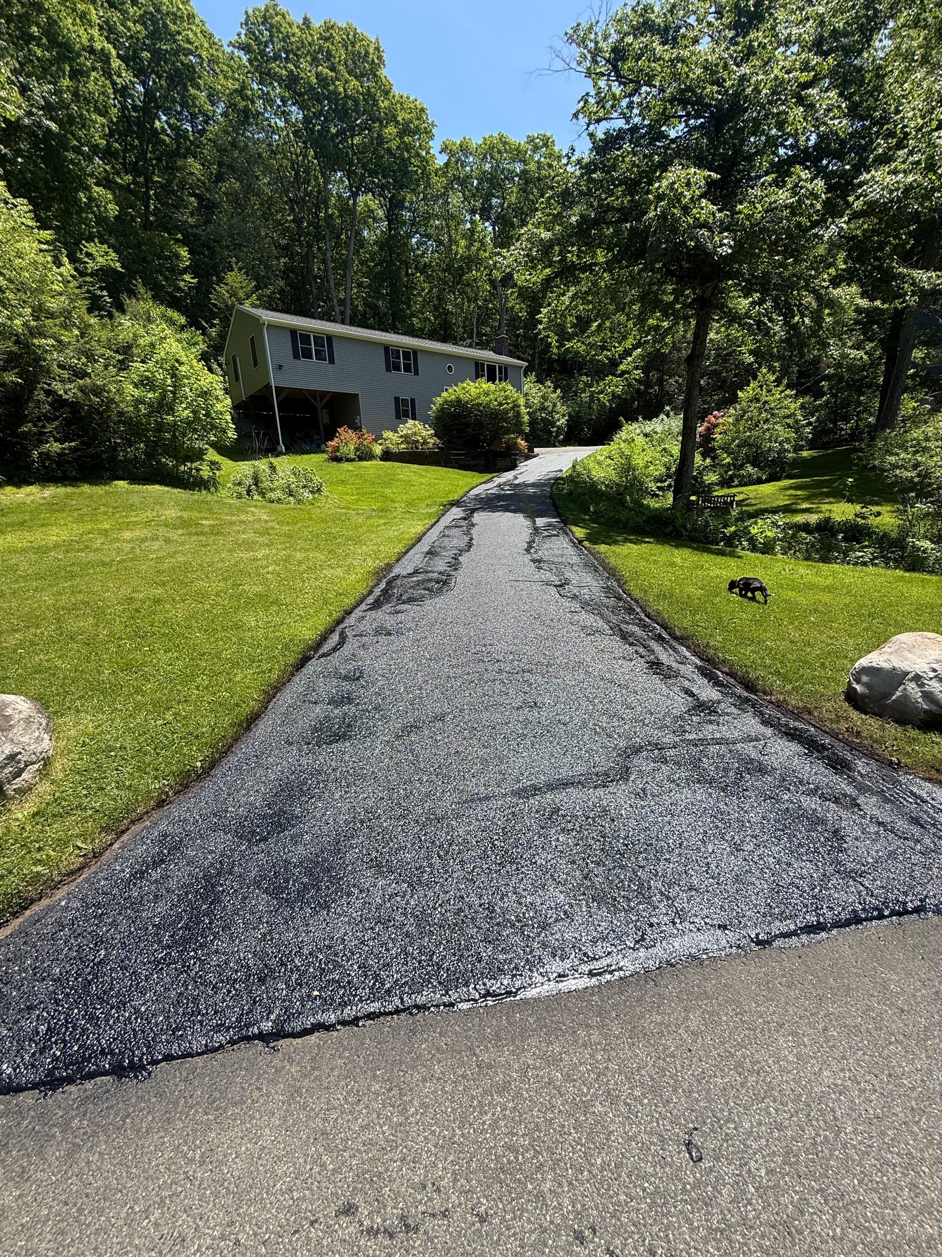 Driveway after crack repairs and sealcoat 