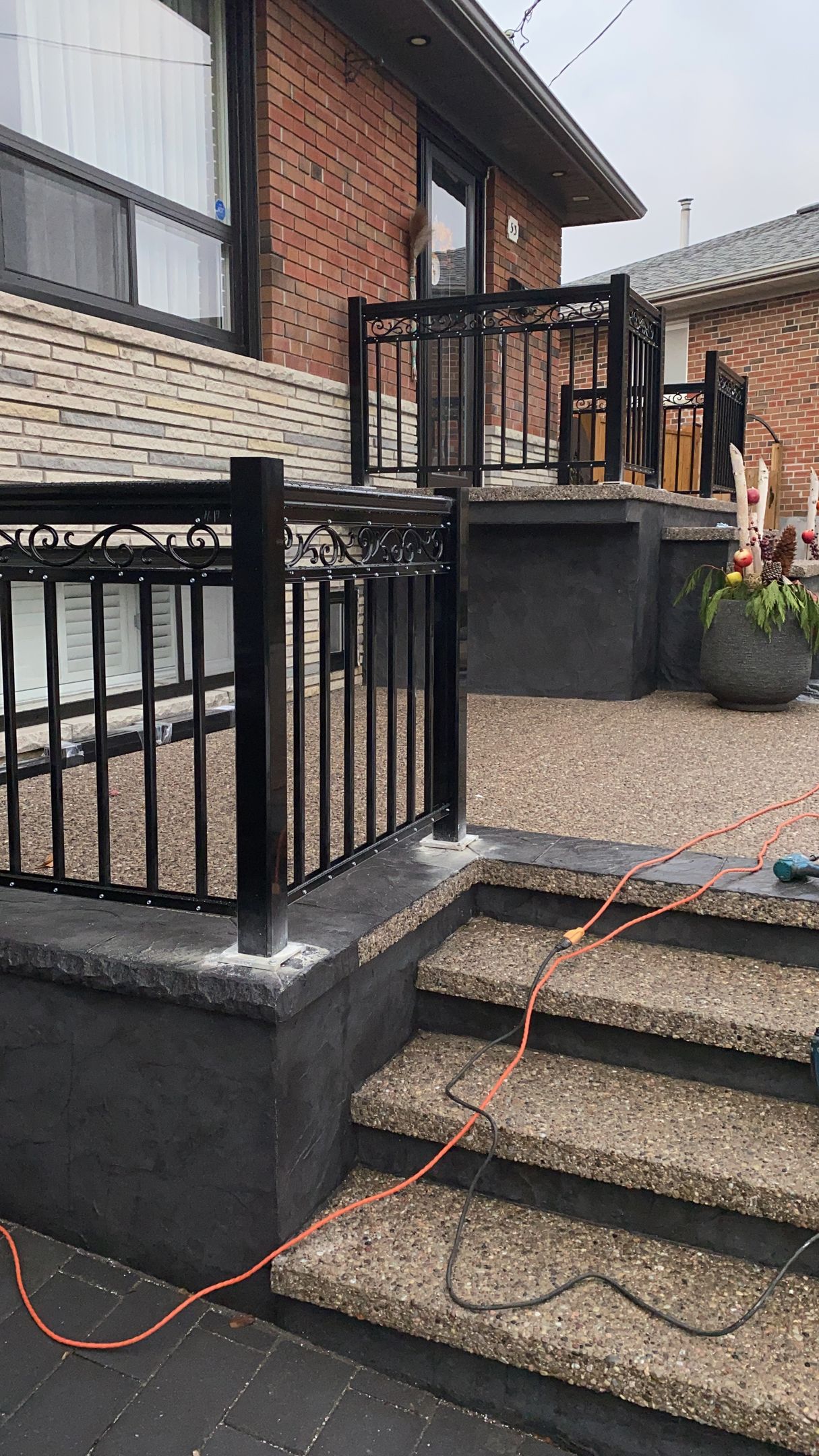 There is a staircase leading up to a deck with a railing.