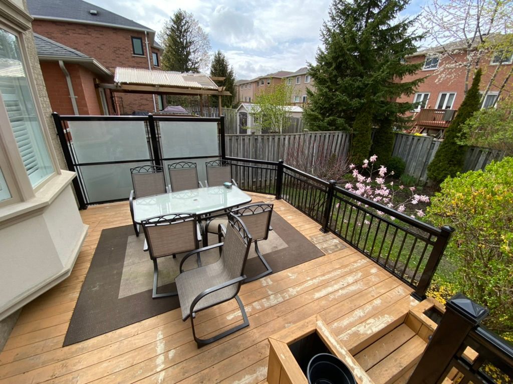 A wooden deck with a table and chairs on it.