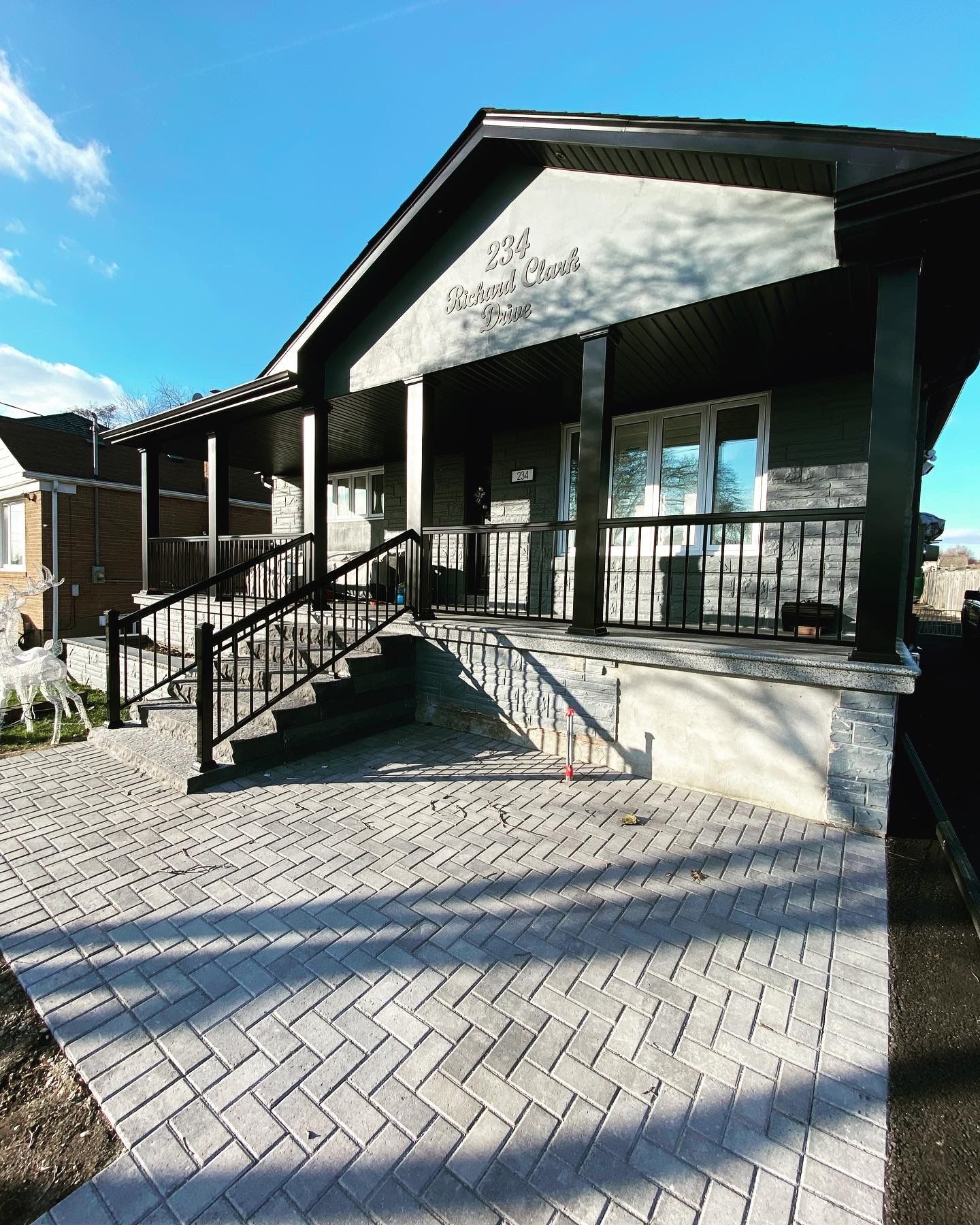 A large house with stairs leading up to the front porch.