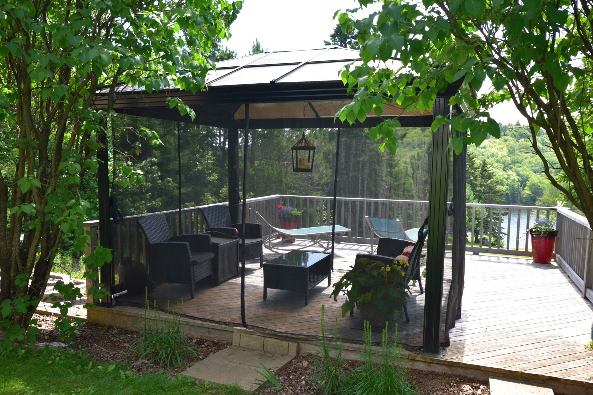 There is a gazebo with a lot of furniture on it.