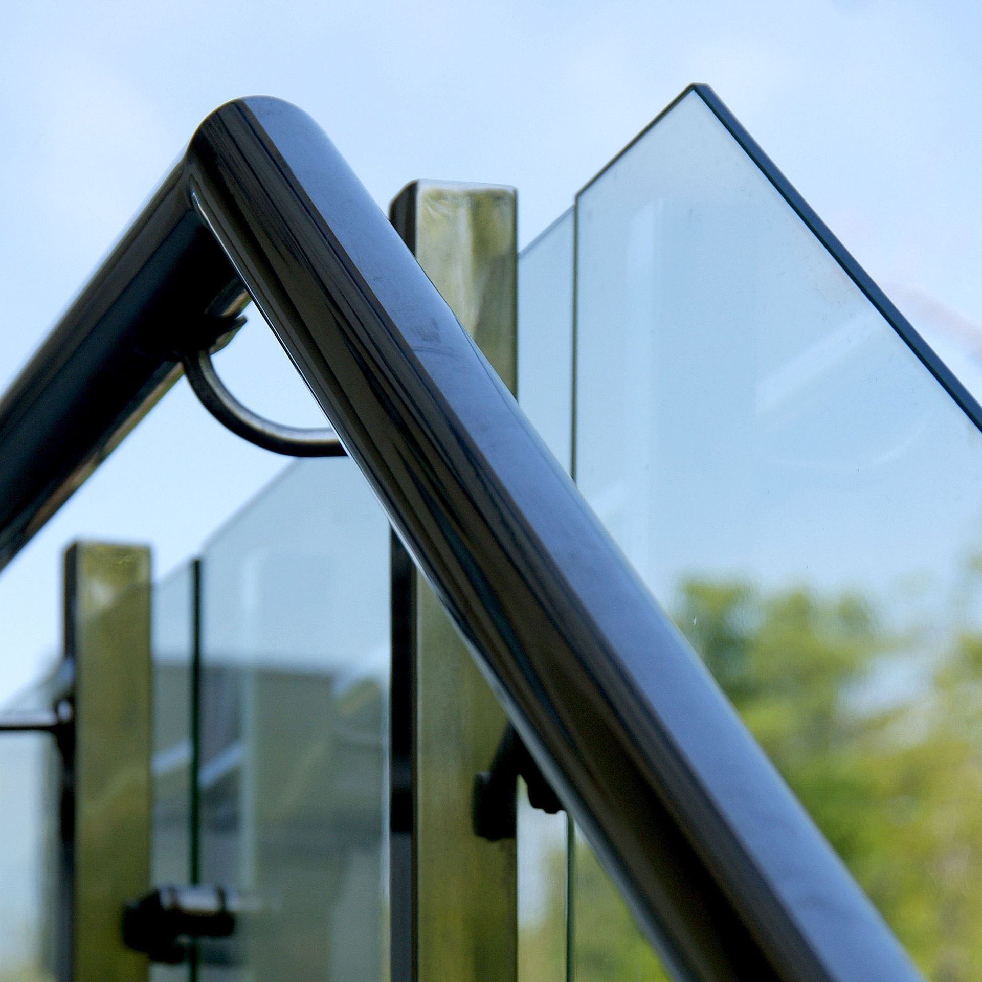 A close up of a railing with a blue sky in the background