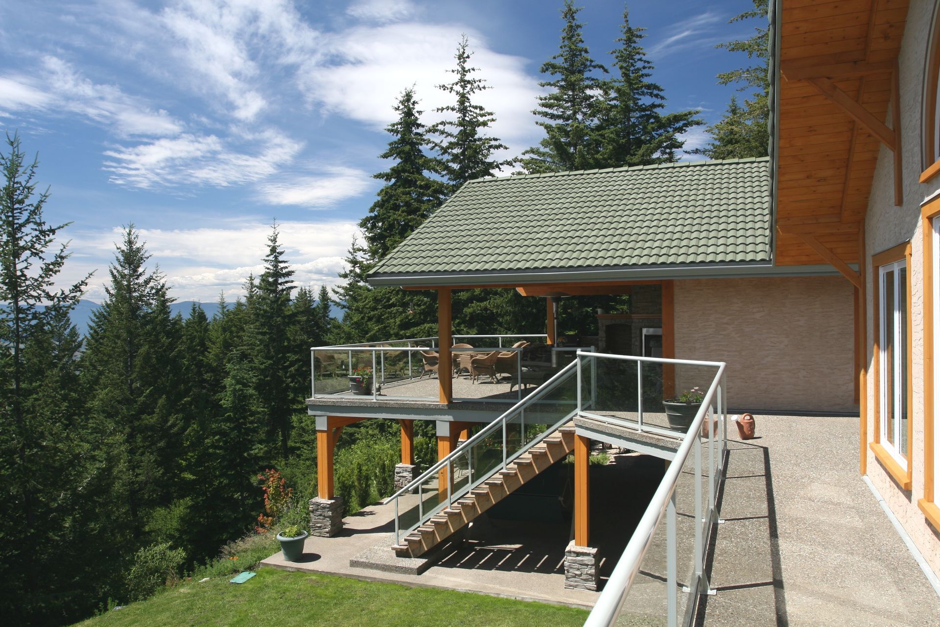 A house with a green roof and stairs leading up to it