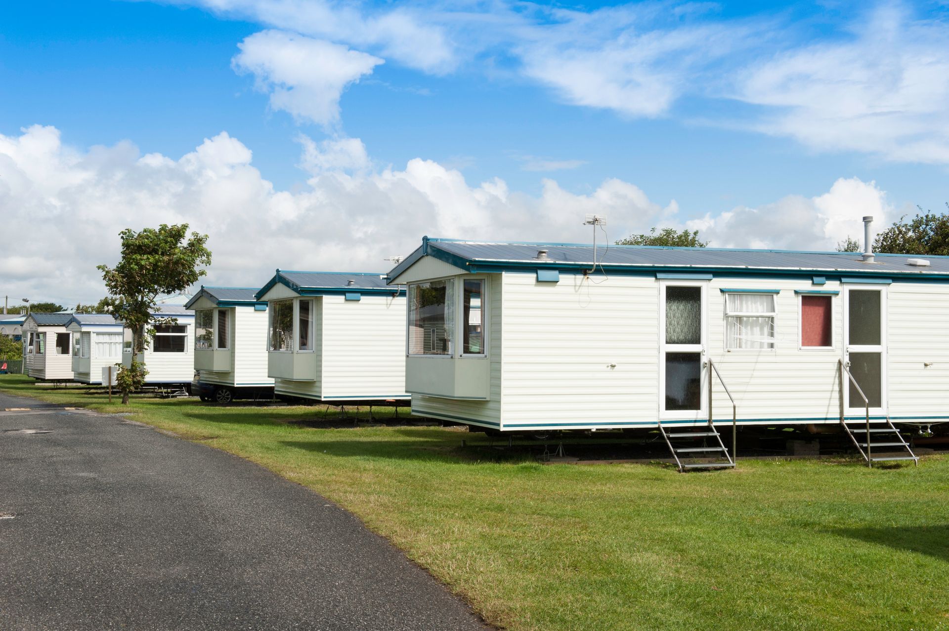 Caravans lined up at a scenic caravan park with greenery and open skies around Caravans lined up at a scenic caravan park with greenery and open skies around