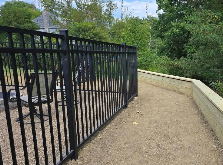 An elegant black aluminum fence with ornate finials, providing a sophisticated and durable boundary.
