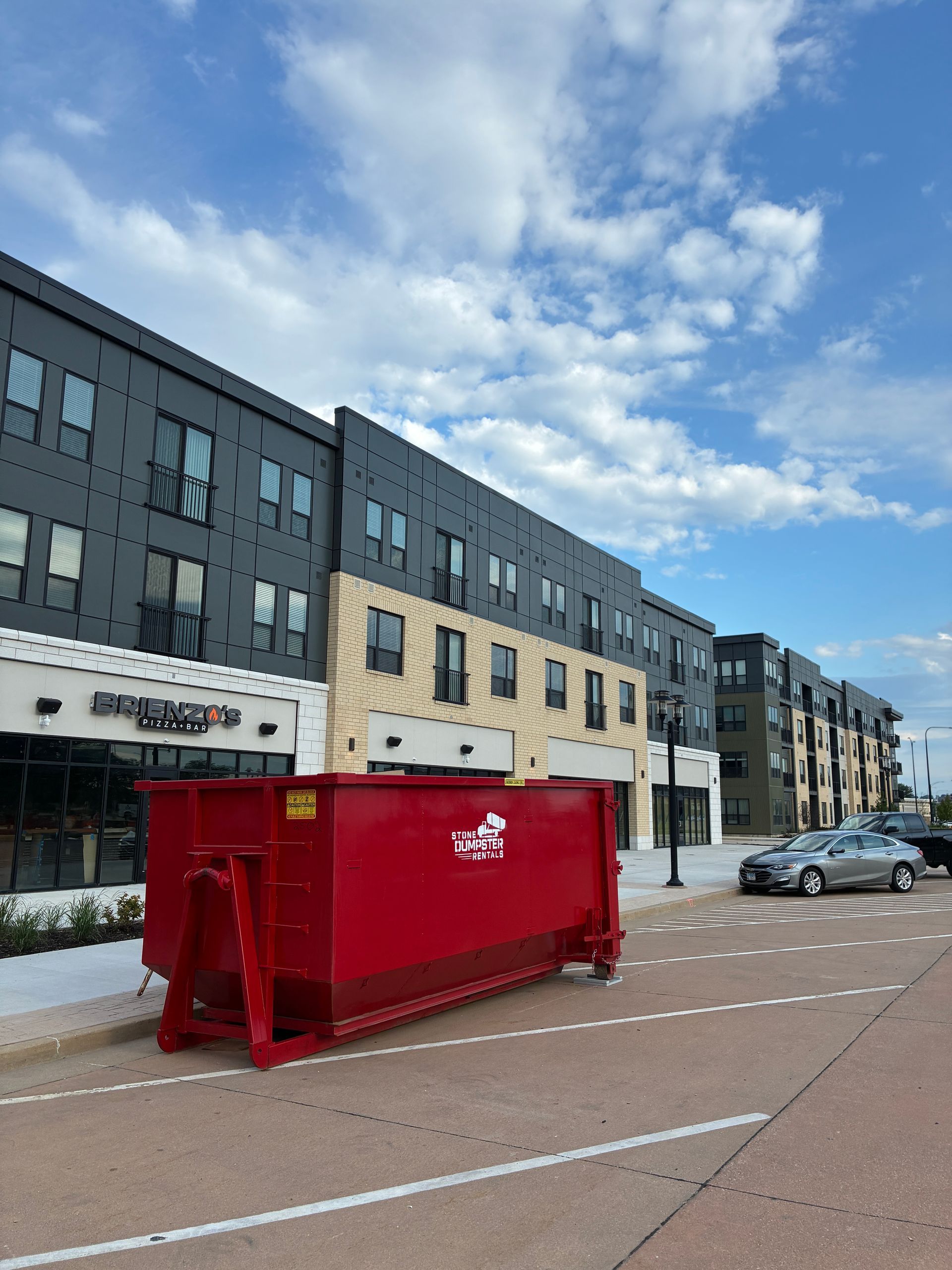 photo with light pole/store fronts: 25 yard dumpster in downtown East Peoria IL