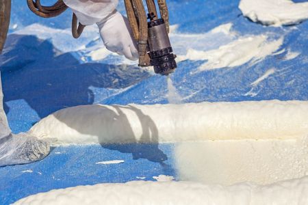 Person holding a metal tool over blue-and-white icy terrain, with snow and frozen blocks visible.