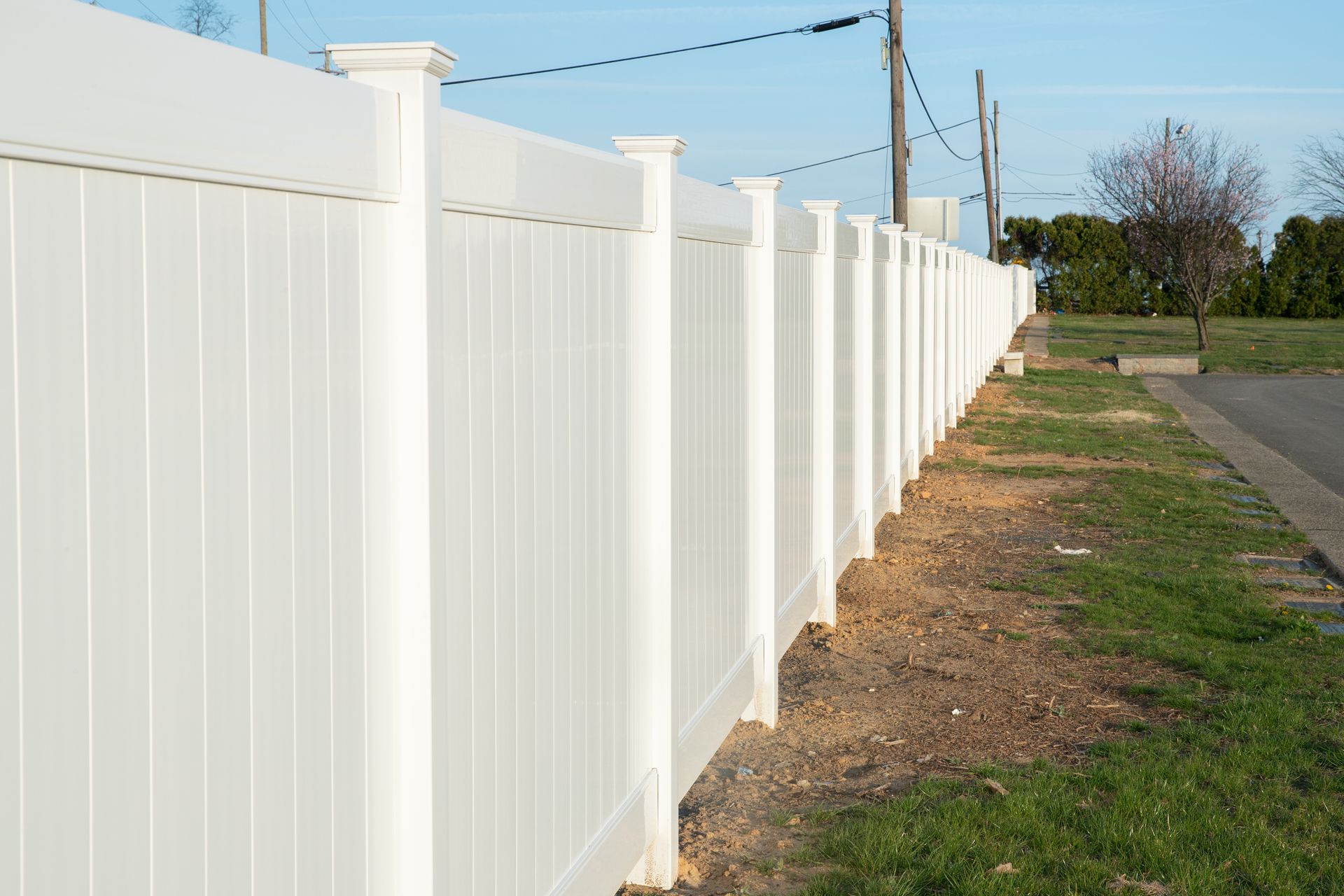 White vinyl fence in residential neighborhood home nature plastic new. White vinyl fence in residential neighborhood home nature plastic new.