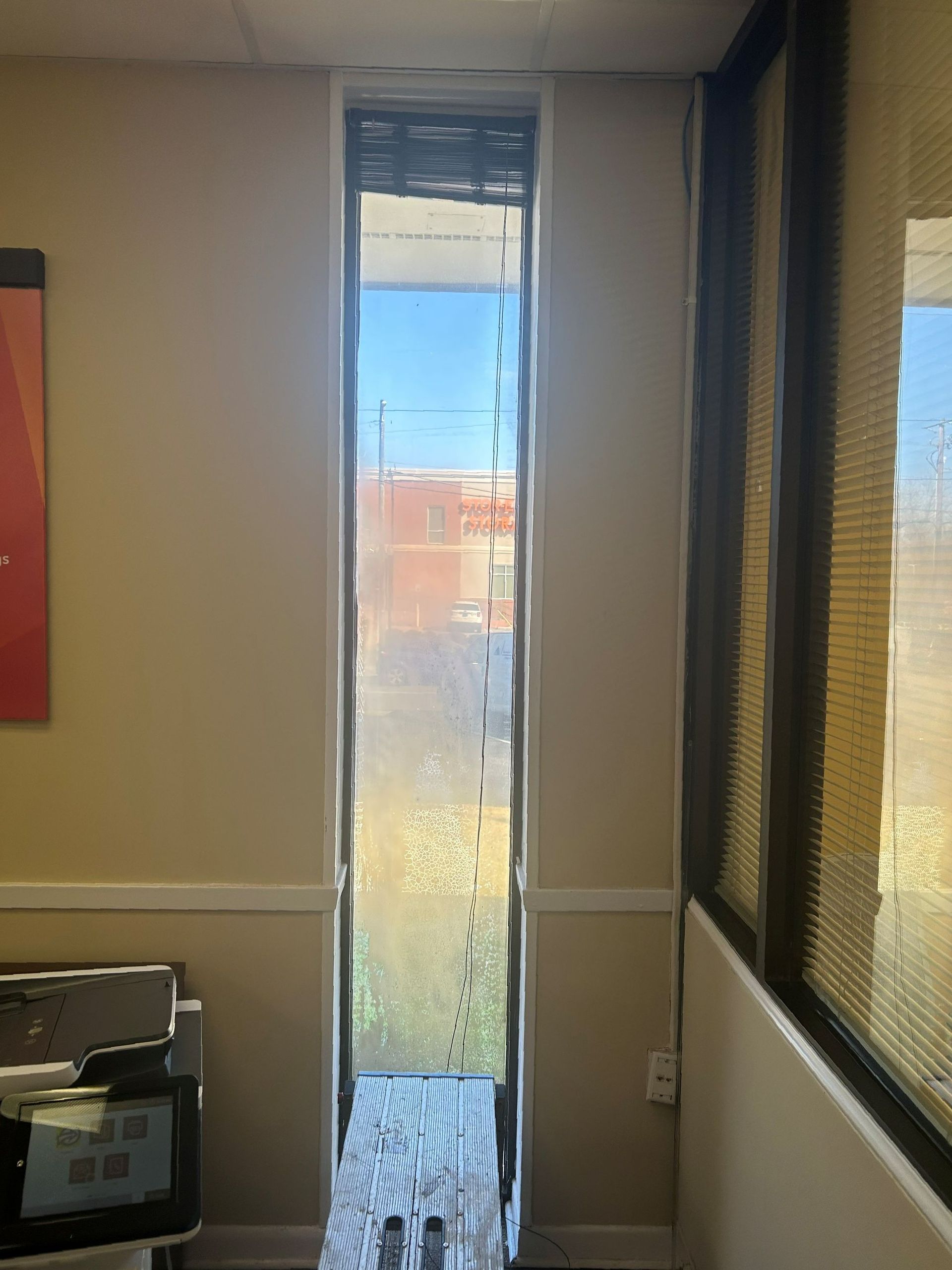tint removal or replacement - Old window tint replacement renewing windows cutting heat glare and full UV-harm from bank windows in Auburn AL. SPF Crystal Clear window tint renews home or office windows in Auburn AL