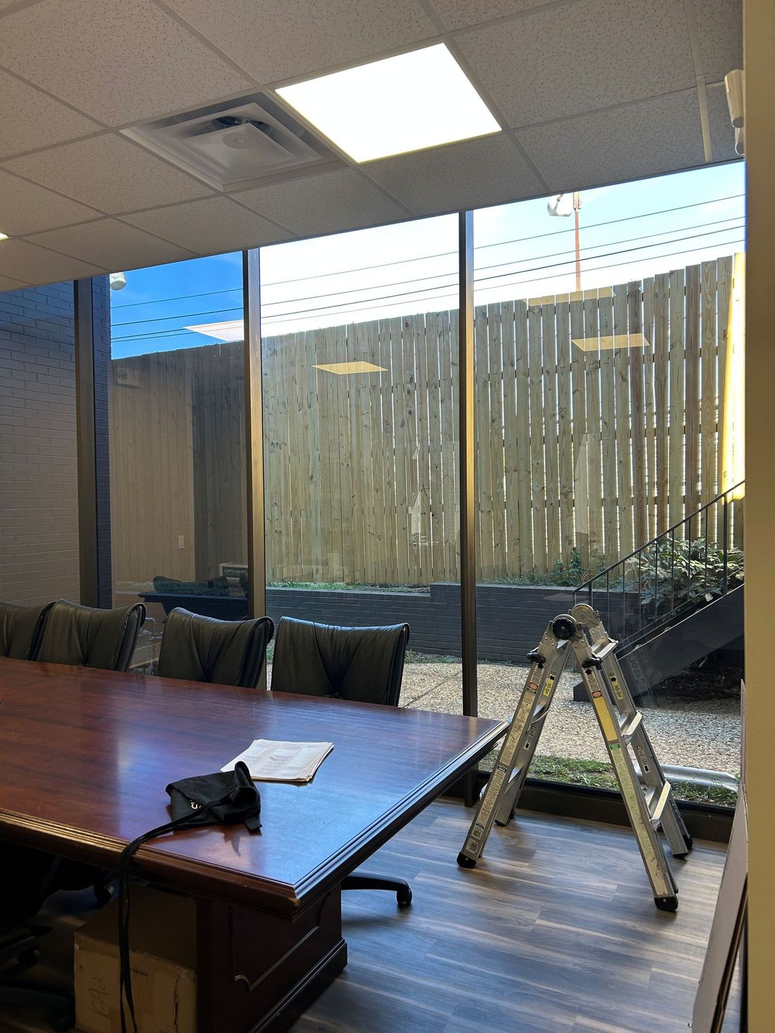 Blinding Sun glare dictated meeting room times. Preventing clear focus and effectiveness inside office windows before SPF Office Tint. Montgomery, AL