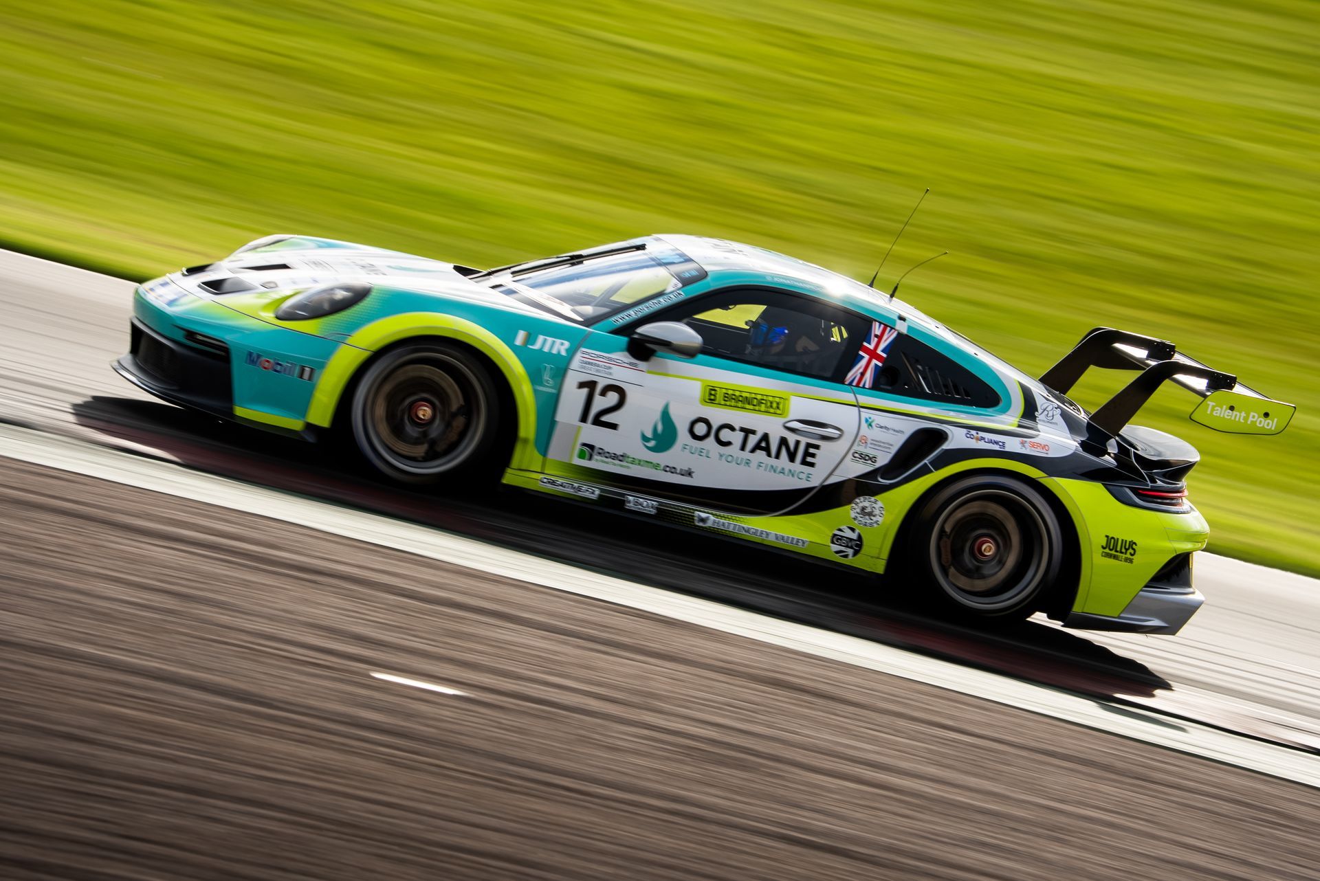 Jonny Moore Motorsport porsche carrera cup car at speed side on 