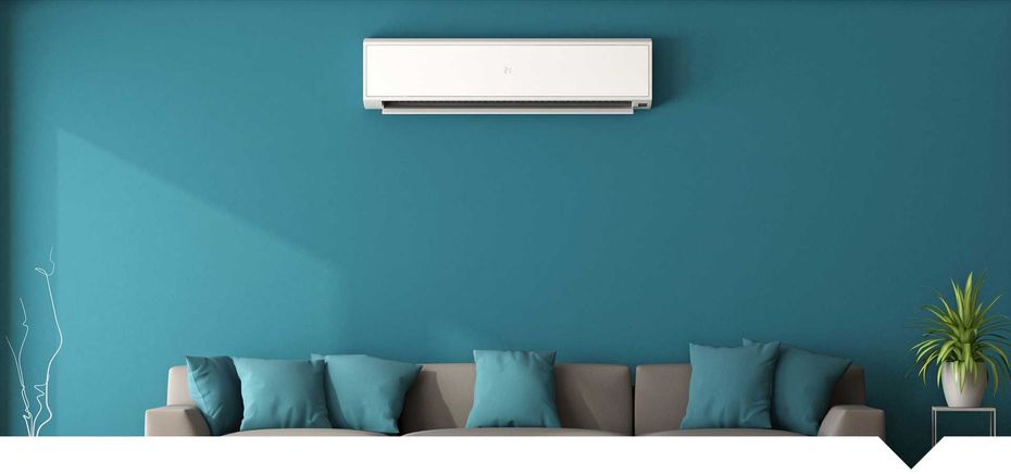 A living room with a couch , air conditioner , and blue walls.