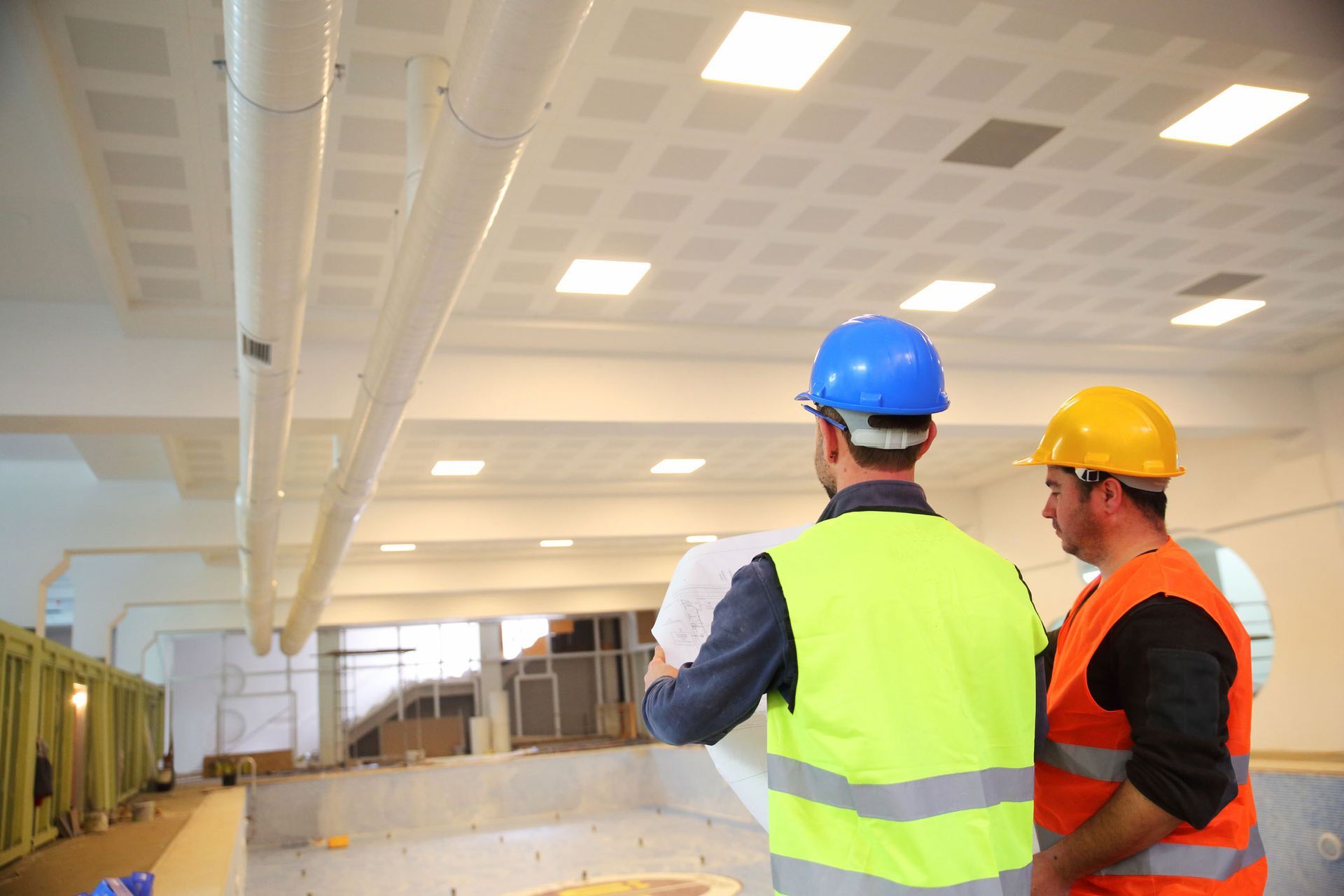Workers reading blueprints | Perth, WA | Commercial Air Solutions