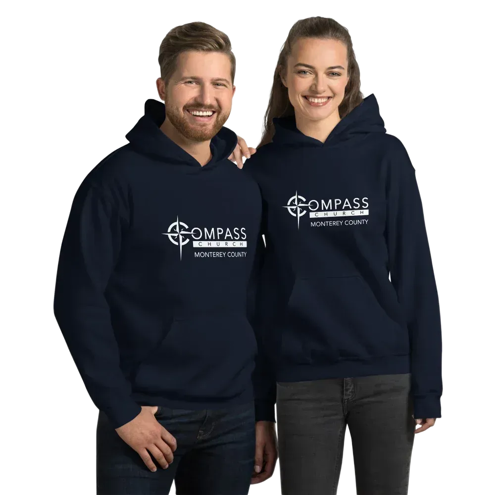 Two people wearing matching navy blue hoodies with a white logo.