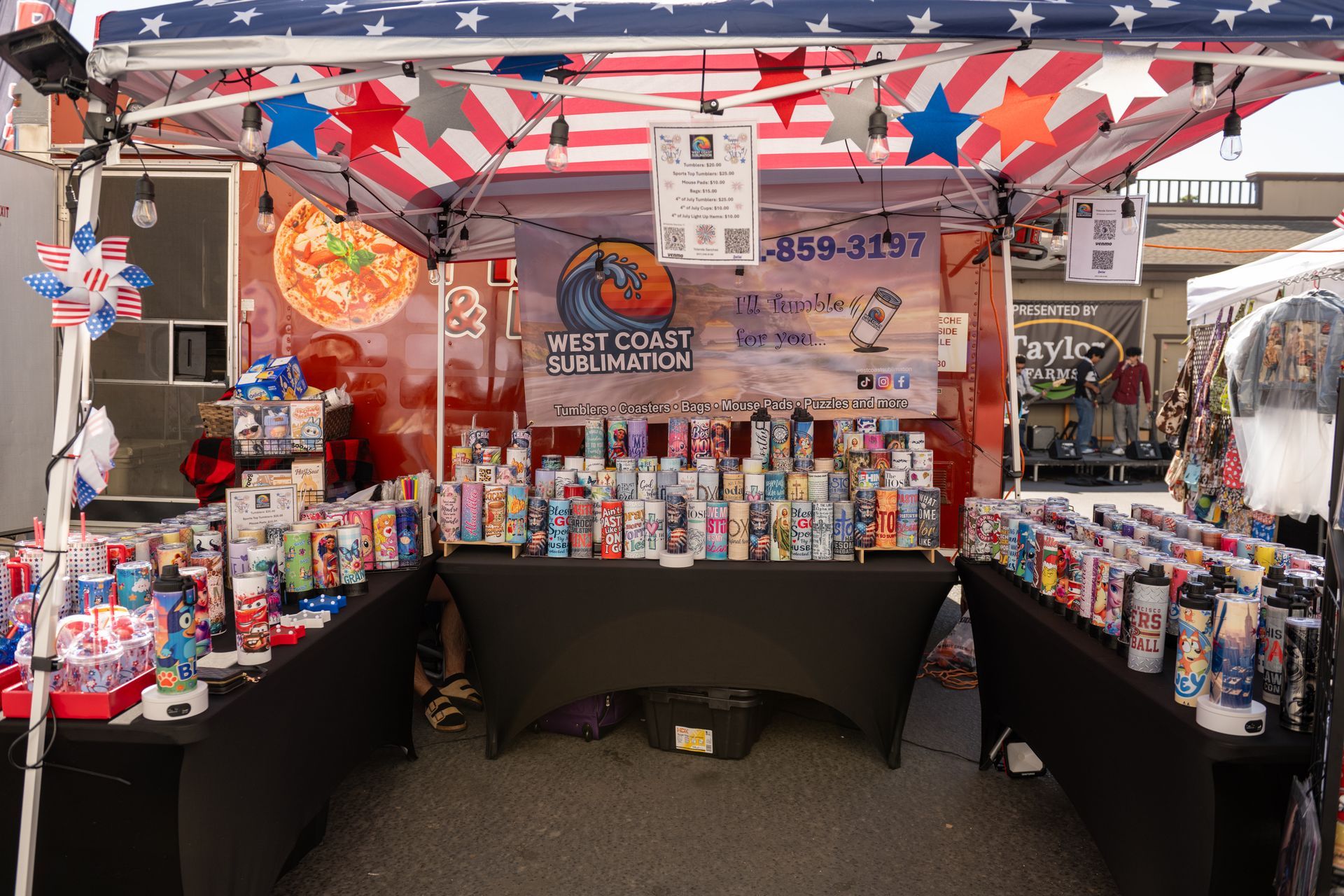 Patriotic-themed market stall with red, white, and blue bunting and rows of bottled drinks and snacks
