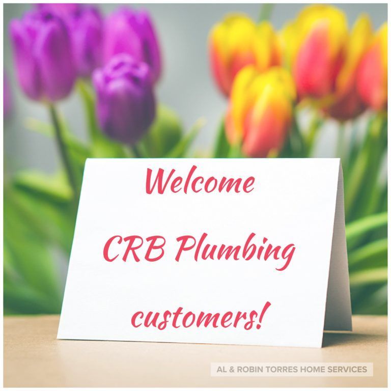 Sign reading “Welcome CRB Plumbing customers!” in front of colorful tulips