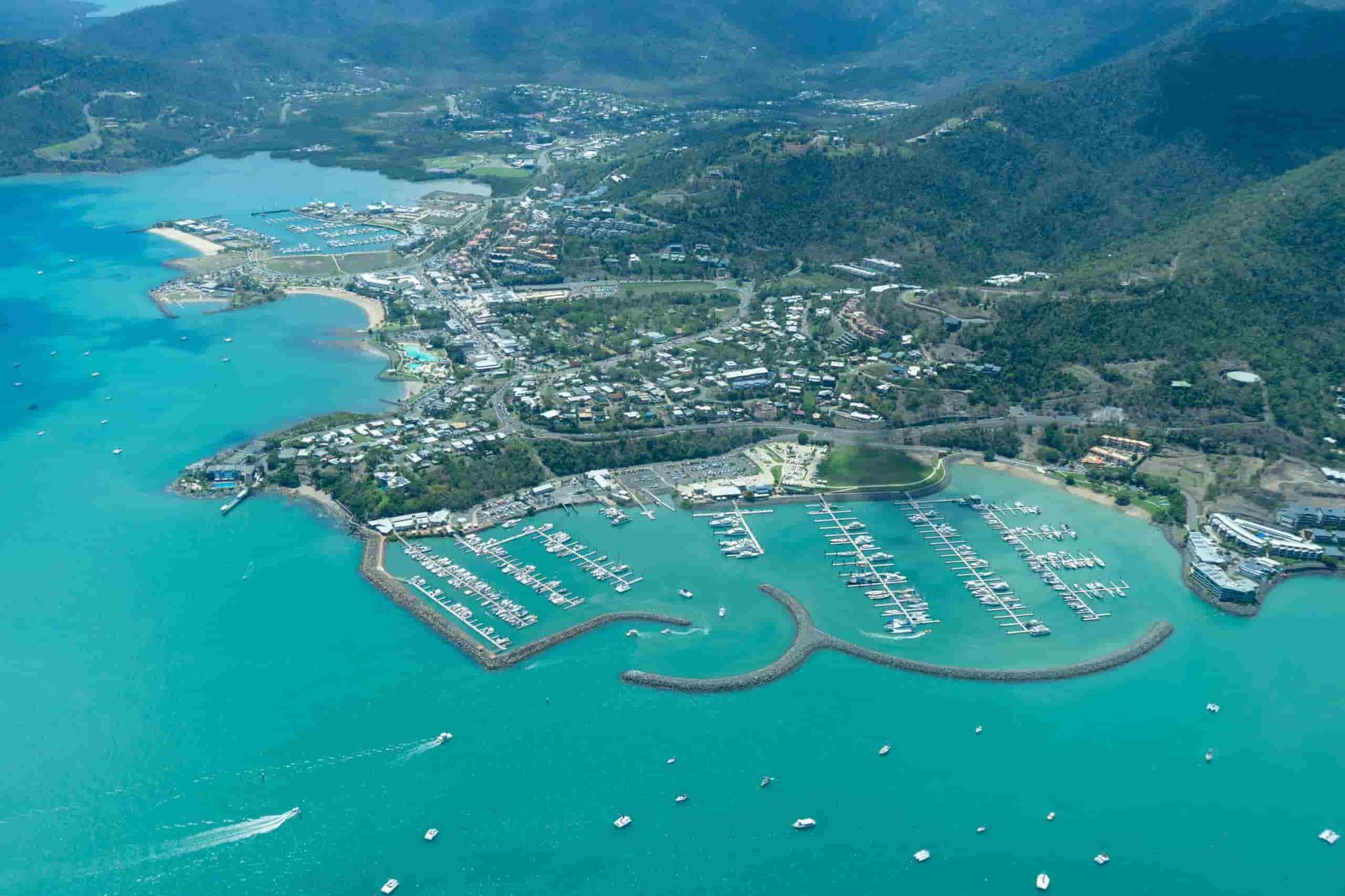 An Aerial View of a Harbor With Boats in It and Mountains in the Background — Refrigerated Technologies (QLD) Pty Ltd In Airlie Beach, QLD