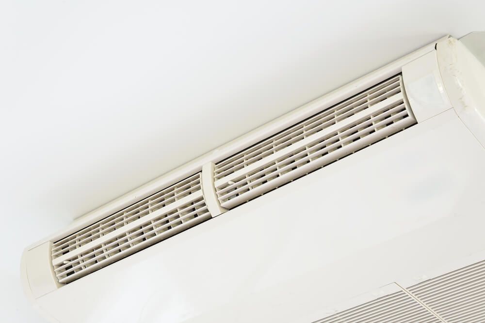 A White Air Conditioner Hangs from the Ceiling in a Room — Refrigerated Technologies (QLD) Pty Ltd In Airlie Beach, QLD